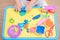 Asian 2 years old toddler baby boy child having fun playing colorful modeling clay / play dought, cooking toys
