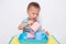 Asian 2 years old toddler boy child having fun pouring water into cup, Wet Pouring Montessori