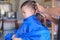 Asian 3 years old toddler baby boy child getting a haircut at the hairdresser`s barber shop