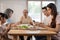 Asian Addicted family use mobile phone while eating breakfast on table. Upset Elderly grandfather feel unhappy angry and troubled