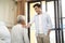 Asian adult son visiting father in hospital or nursing home