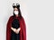 Asian adult woman wear hygiene face mask and vampire cloak costume fashion in clasp hand gesture with confident pose for Horror