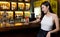 Asian alone women enjoy cocktails in front of a vintage bar, Relaxing activities after work or hangouts