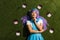 Asian anime girl in purple wig with emoticons lying on grass
