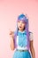Asian anime girl in wig showing idea sign on pink