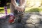 Asian athletes are stretching his legs before running work out on road in park.