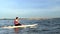 Asian athletic woman on stand paddle board in lake. Solo outdoor SUP activity and water sport on summer holiday