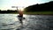 Asian athletic woman on stand paddle board in lake. Solo outdoor SUP activity and water sport on summer holiday