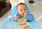 Asian baby boy 6 months old eating with Baby Led Weaning BLW method, Self-Feeding