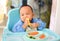 Asian baby boy 6 months old eating with Baby Led Weaning BLW method, Self-Feeding