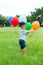 Asian baby boy play with bunch of balloon