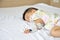 Asian baby boy sleeping on bed with infusion set at child department in the hospital.