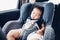 Asian baby boy travel in car seat and sleeping