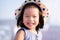Asian baby child girl beaming smiling. Close up happy face. Little girl wearing white hat. Half body photo. She has tooth decay.