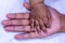 ASIAN BABY GIRL BEAUTIFUL HAND ON HER MOTHERS HAND