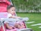 Asian baby girl look joyful sitting in stroller.