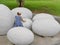 Asian baby girl touching a dinosaur egg to explore if she feels anything inside