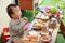 Asian baby playing with camping gear toy tools on the wooden table