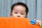 Asian baby in playpen