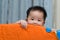 Asian baby in playpen