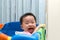 Asian baby in playpen