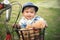Asian baby sitting in bicycle basket,vintage tone