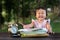 Asian baby toddler drawing at park while making funny face