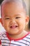 Asian baby of toddler and have teething in smile with happily.