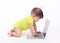 Asian baby typing on modern laptop