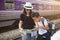 Asian backpack traveler mother with son using generic local map at a train station