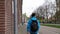 Asian backpacker man walk alone in European city street of Amsterdam