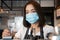 Asian barista women wearing face masks to prevent contagious diseases and serve customers in the coffee shop. The concept of