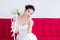 Asian beautiful bride sitting on red sofa, shopping concept, women seeking foreigner dating, girl close eyes dream to perfect man