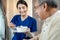 Asian beautiful therapist doctor serve food to older patient in house. Young woman nurse at nursing home taking care of disabled