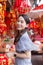 Asian beautiful woman in grey dress smiles in Chinese New Year theme