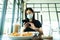An Asian beautiful woman has to wear a blue mask and prepare to start breakfast in the coffee cafe with new normal and social-