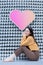 Asian beautiful woman with long hair is sitting and closing her eyes in heart background as Valentineâ€™s day concept. abstract