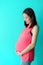 Asian beautiful woman Pink pink Standing, holding his hand to his stomach That is growing because of pregnancy Happily waiting for