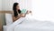 Asian beautiful woman reading work book on the bed in morning.