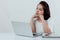 Asian beautiful woman Sitting in a white shirt On the front desk, there is a laptop computer placed. Expression There is work