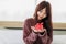 Asian beautifull woman holding red gift box and happiness in her bed room. Stay at home