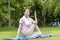 Asian Beauty and healthy woman exercise and doing meditation of yoga on exercise mat in the morning exercise in the park. -