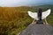 Asian beauty woman with bird wings at the back, sitting on the rocks in the mountains.