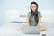 Asian beauty woman sitting on the bed and playing notebook computer on bed for relaxing.