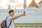 Asian blogger man travel in Bangkok, Thailand, backpacker male using mobile phone make vlog and live in social media while