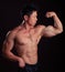 Asian Body Builder flexing left bicep