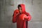 Asian Boxer in red hood with wall grunge background.