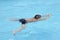 Asian boy breast stroke swims in swimming pool