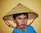 Asian boy with the chinese conical bamboo hat