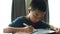 Asian boy drawing on digital tablet.